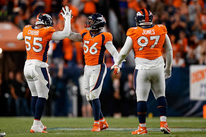 Denver Broncos linebacker Baron Browning (56) celebrates after a play with linebacker Bradley Chubb (55) and defensive tackle D.J. Jones (97) in the second quarter against the Indianapolis Colts at Empower Field at Mile High.